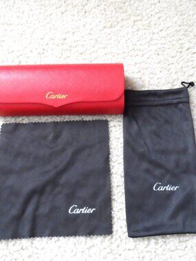 Cartier - red hard shell glasses case, black cleaning cloth and pouch.